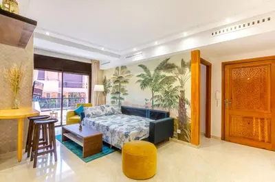 a living room with a couch and a table at Le Palmier - Appartement Authentique à Gueliz in Marrakech