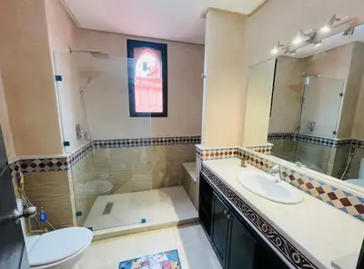 a bathroom with two sinks and a mirror at The Villa avec piscine chauffée 4 chambres in Marrakech