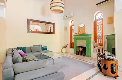 a living room with a couch and a fireplace at The Majestic Marrakesh Villa 16 in Marrakech