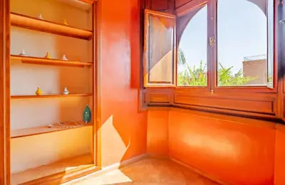 an orange room with a window and shelves at The Majestic Marrakesh Villa 16 in Marrakech