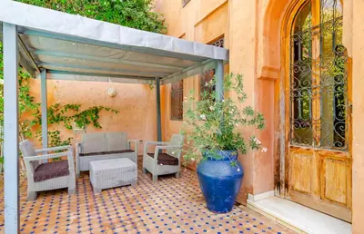 a large blue vase sitting on a patio at The Majestic Marrakesh Villa 16 in Marrakech