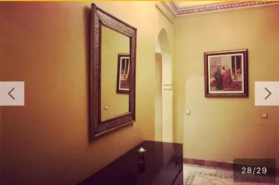 a mirror on a wall with a table in a room at palmeraie village 2 in Marrakech