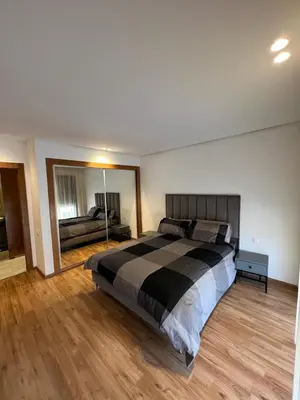 a bedroom with a bed and a large mirror at Appartement deux chambres salon Centre de Gueliz 23 in Marrakech