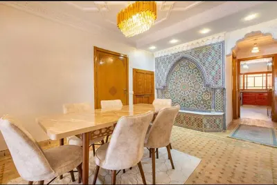 a dining room with a table and chairs at Luxury Appartement gueliz center in Marrakech
