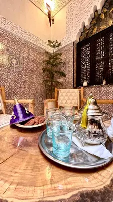 a table with plates of food and drinks on it at Riad Hayat in Marrakech
