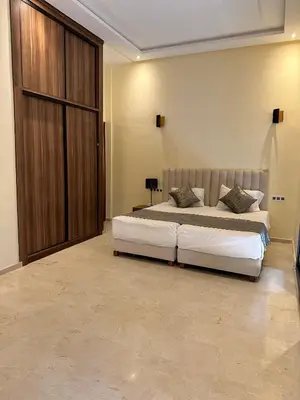 a bedroom with a large bed and a large closet at Villa avec pool privé avenue Mohamed 6 zone touristique Agdal in Marrakech