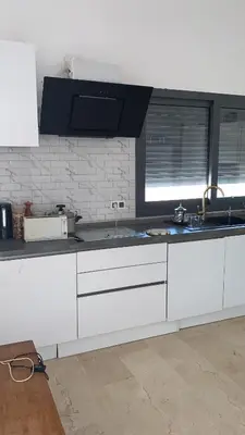 a kitchen with white cabinets and a sink at Villa avec pool privé avenue Mohamed 6 zone touristique Agdal in Marrakech