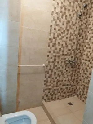 a bathroom with a shower with a toilet in it at Luxury Apartment Marrakesh in Marrakech