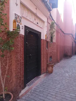 a black door on the side of a building at Riad El Badii chambre twin Bahia in Marrakech