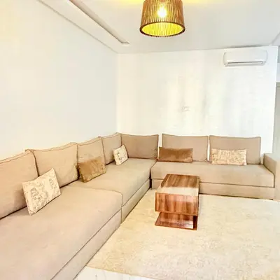 a living room with a couch and a coffee table at Studio N9 COSY Avec Balcon in Marrakech