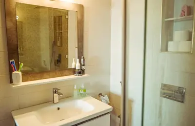 a bathroom with a sink and a shower with a mirror at Apartment in Marrakech in Marrakech