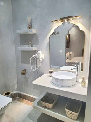 a bathroom with a sink and a mirror at Riad Isahiac avec piscine en exclusivité in Marrakech