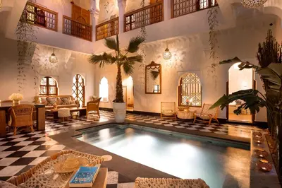 a large room with a swimming pool in a house at Riad LallaBaya in Marrakech