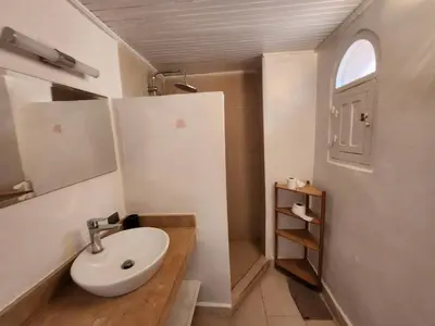 a bathroom with a white sink and a mirror at Suite dans la palmeraie refaite à neuf grande Terrasse Dar Dmana in Marrakech