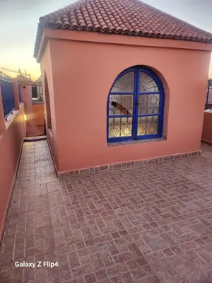 a house with a large window on the side of it at Riad Izza in Marrakech