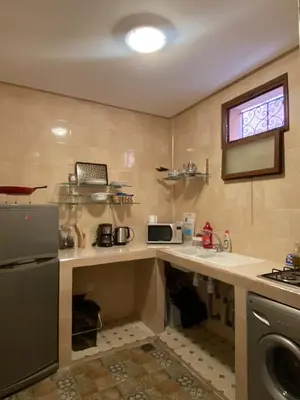 a kitchen with a sink and a microwave at Private Riad 3ch Salon, Terrasse avec Jacuzzi , à Jemaa El Fna in Marrakech