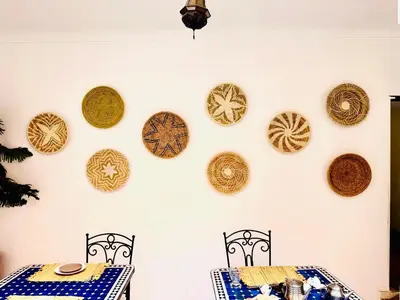 a dining room with plates on the wall at Riad Dar Lilas in Marrakech