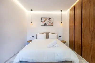 a bedroom with a large white bed with two pillows at Contemporary luxe, heart of Gueliz fibre optq IPTV in Marrakech