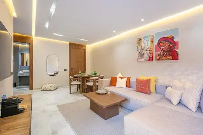 a living room with a couch and a table at Contemporary luxe, heart of Gueliz fibre optq IPTV in Marrakech