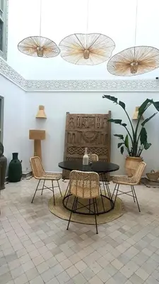 a dining room with a table and two chairs at Riad M17 & Spa - Médina in Marrakech