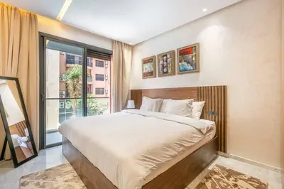 a bedroom with a large bed and a large window at Peaceful Living: Chic Apartment, Prime Location in Marrakech