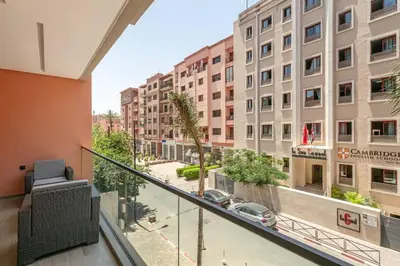 a balcony with a view of a street and buildings at Peaceful Living: Chic Apartment, Prime Location in Marrakech