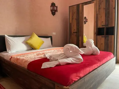 two stuffed animals are sitting on a bed at Riad La Bigarade in Marrakech