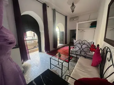 a living room with a couch and a table at Riad el Adraoui in Marrakech