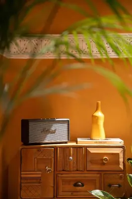 a wooden cabinet with a vase on top of it at Riad Le Petit Bacha in Marrakech