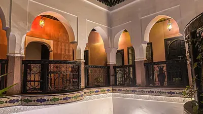 a room with a balcony and a tub in a building at Riad Safir Marrakech in Marrakech