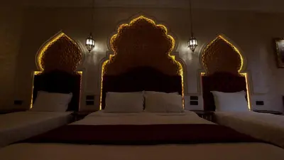 two beds in a hotel room with two large beds at Riad Safir Marrakech in Marrakech