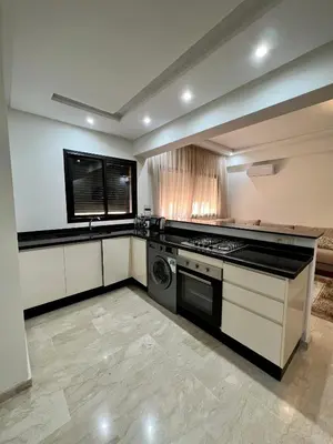 a kitchen with a stove and a dishwasher at Apparemment deux chambres salon 16 in Marrakech