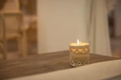 a candle sitting on top of a wooden table at Les Palmiers Boutique Hôtel & Spa in Marrakech
