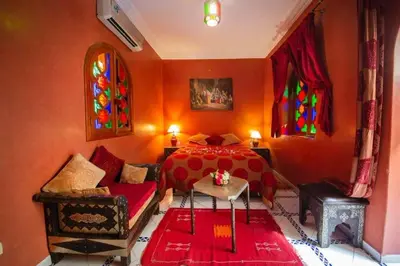 a bedroom with a bed and stained glass windows at La lune de Marrakech Riad in Marrakech