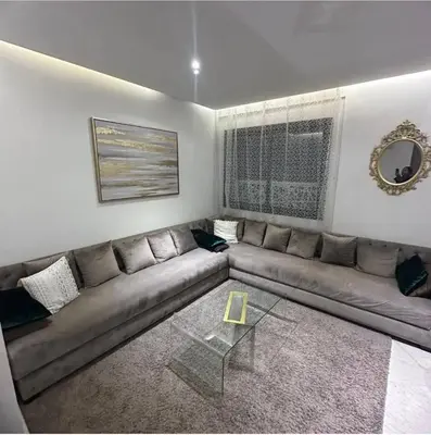 a living room with a couch and a glass table at Chez Dar safaa in Marrakech