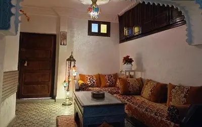 a living room with a couch and a table at Riad Anisse in Marrakech