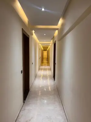 a hallway with a long corridor with lights on the ceilings at Nour 5 marrakech in Marrakech