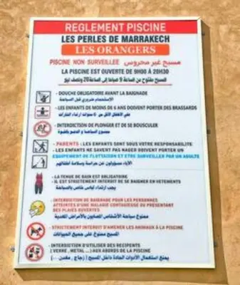 a sign for a restaurant with a list of prohibited substances at Magnifique appartement spacieux avec une belle terrasse ensoleillée in Marrakech