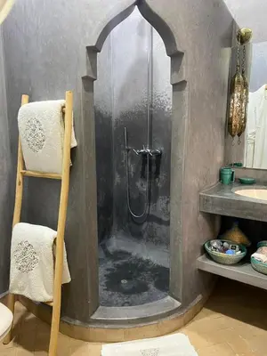 a bathroom with a shower with water in it at Riad des Fragrances dar el Bacha in Marrakech