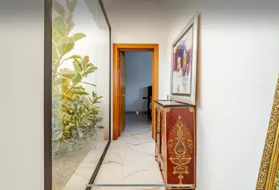 a hallway with a mirror and a wooden cabinet at Manzal Vista in Marrakech
