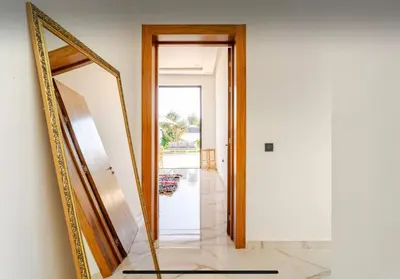 a mirror on a wall next to a hallway at Manzal Vista in Marrakech