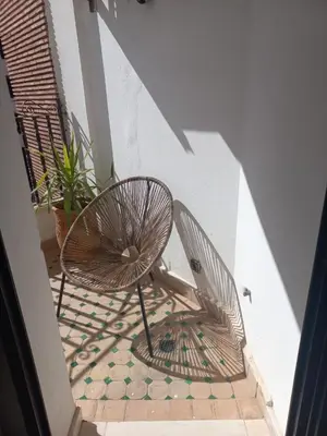 a pair of chairs sitting on a balcony at Belle Vue in Marrakech