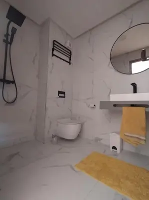 a white bathroom with a sink and a toilet at Belle Vue in Marrakech