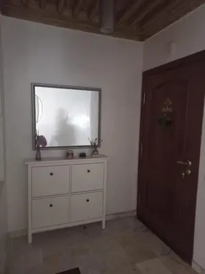 a room with a dresser with a mirror and a door at Belle Vue in Marrakech