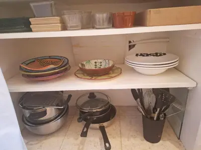 a kitchen shelf with dishes and utensils on it at DUPLEX MEDINA AVEC TERRASSE in Marrakech