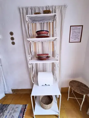 a white shelf with bowls and plates on it at STUDIO LOFT MEDINA AVEC TERRASSE in Marrakech