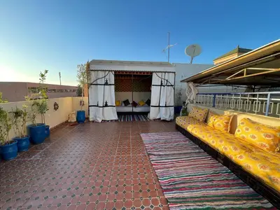 an outdoor patio with a couch on a building at Riad Mama Toutou in Marrakech