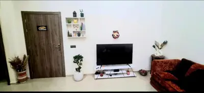a living room with a flat screen tv on a wall at Charming Room Near Marrakech Airport in Marrakech