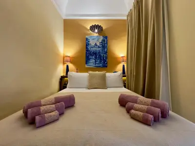 a bedroom with a large bed with two pillows at Riad Taghia in Marrakech
