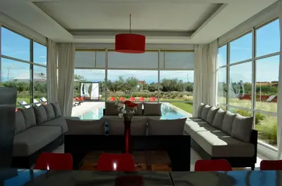 a large living room with couches and a pool at Villa Loanaelle in Marrakech